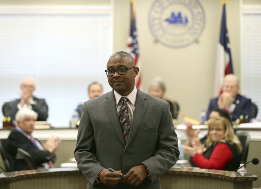 In this Thursday, Dec. 14, 2017 photo, Vernon Hale, deputy chief of police for the Dallas Police Department, receives applause after being confirmed as Galveston's new Police Chief by the city council, in Galveston, Texas. (Jennifer Reynolds /The Galveston County Daily News via AP)