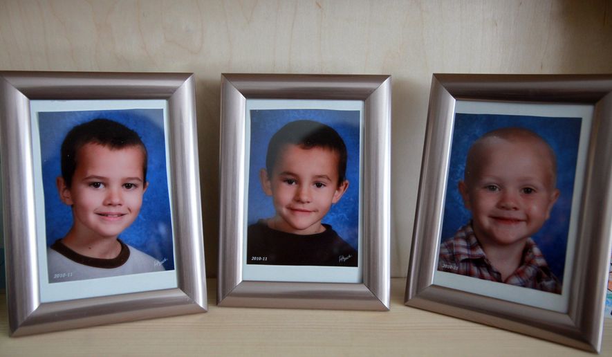 FILE - In this Dec. 22, 2010, file photo, portraits of three missing Morenci, Mich. boys: Andrew, Alex and Tanner Skelton are displayed on a shelf in their grandparents home. Authorities say it could take months before DNA from the remains of three children found in Montana can be compared to DNA in the 2010 disappearance of the three Michigan brothers. The boys were 9, 7 and 5 when they were last seen at their father's Michigan home in November 2010. The boys' father, John Skelton, has said he didn't harm his sons. He's in prison after pleading no contest to unlawful imprisonment for not returning them to their mother after Thanksgiving. (Regina H. Boone//Detroit Free Press via AP, File)