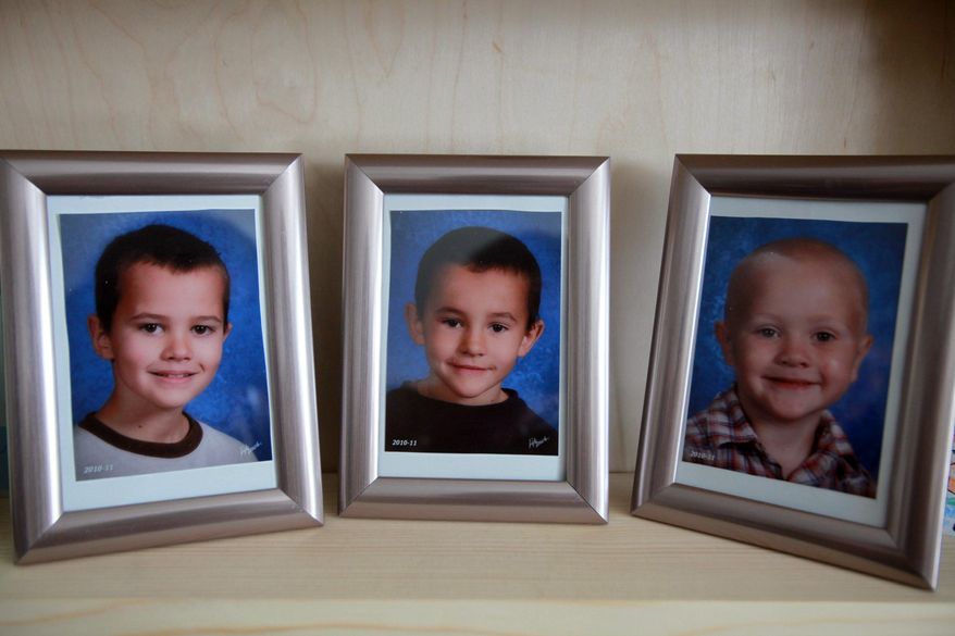 FILE - In this Dec. 22, 2010, file photo, portraits of three missing Morenci, Mich. boys: Andrew, Alex and Tanner Skelton are displayed on a shelf in their grandparents home. Authorities say it could take months before DNA from the remains of three children found in Montana can be compared to DNA in the 2010 disappearance of the three Michigan brothers. The boys were 9, 7 and 5 when they were last seen at their father's Michigan home in November 2010. The boys' father, John Skelton, has said he didn't harm his sons. He's in prison after pleading no contest to unlawful imprisonment for not returning them to their mother after Thanksgiving. (Regina H. Boone//Detroit Free Press via AP, File)