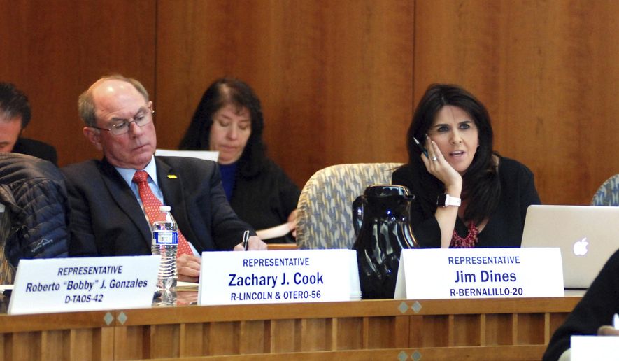 New Mexico state Reps. Jim Dines, R-Bernalillo, left, and. Kelly Fajardo, R-Belen, attend a meeting of state lawmakers on Friday, Dec. 15, 2017, in Santa Fe, N.M., about proposed revisions to the state Legislature's policy against sexual harassment. The two lawmakers have taken on leading roles as the New Mexico Legislature is rewrites its anti-harassment policy in response to concerns that widespread misconduct has gone unchecked. Statehouses nationwide are wrestling with new revelations about sexual misconduct. (AP Photo/Morgan Lee)