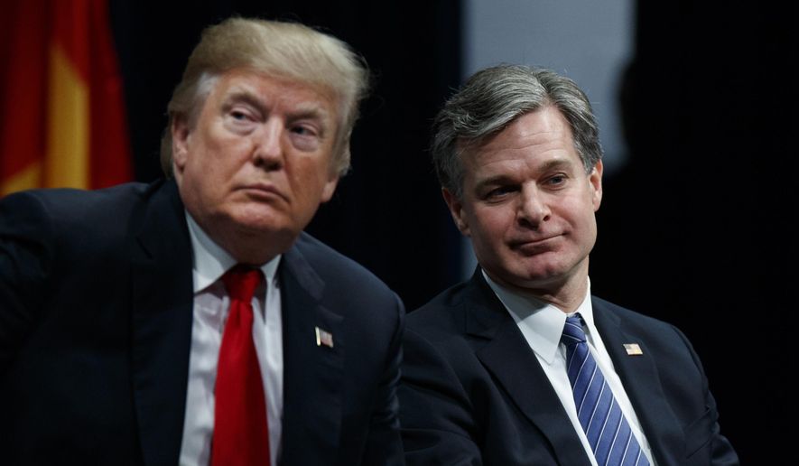 President Donald Trump sits with FBI Director Christopher Wray during the FBI National Academy graduation ceremony, Friday, Dec. 15, 2017, in Quantico, Va. (AP Photo/Evan Vucci) ** FILE **