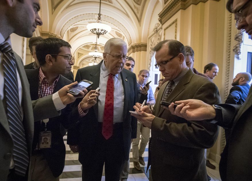 Reporters interview Sen. Mike Enzi, R-Wyo., chairman of the Senate Budget Committee, as arrives to meet with House Ways and Means Committee Chairman Kevin Brady, R-Texas, at the Capitol to advance the GOP tax bill, in Washington, Friday, Dec. 15, 2017. (AP Photo/J. Scott Applewhite)