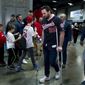 Washington Nationals Daniel Murphy, right walks with crutches during the Winter Fest celebration with fans at Washington Convention center in Washington, Saturday, Dec. 16, 2017. ( AP Photo/Jose Luis Magana) ** FILE **