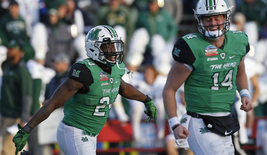 Marshall running back Keion Davis (24) celebrates with quarterback Chase Litton (14) after scoring a touchdown against Colorado State during the first half of the New Mexico Bowl NCAA college football game in Albuquerque, N.M., Saturday, Dec. 16, 2017. (AP Photo/Andres Leighton)