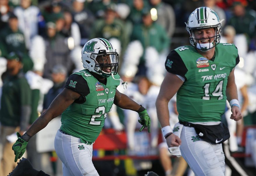 Marshall running back Keion Davis (24) celebrates with quarterback Chase Litton (14) after scoring a touchdown against Colorado State during the first half of the New Mexico Bowl NCAA college football game in Albuquerque, N.M., Saturday, Dec. 16, 2017. (AP Photo/Andres Leighton)