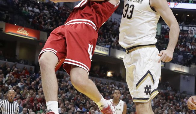 Indiana&#x27;s Zach McRoberts is fouled by Notre Dame&#x27;s John Mooney (33) as he goes up for a shot during the first half of an NCAA college basketball game, Saturday, Dec. 16, 2017, in Indianapolis. (AP Photo/Darron Cummings)