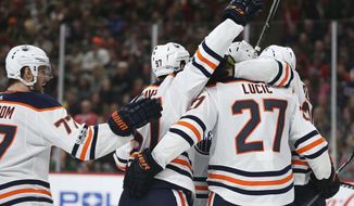 Edmonton Oilers&#39; Milan Lucic (27) celebrates with teammates after scoring the team&#39;s second goal in the second period of an NHL hockey game against the Minnesota Wild, Saturday, Dec. 16, 2017, in St. Paul, Minn. (AP Photo/Stacy Bengs)