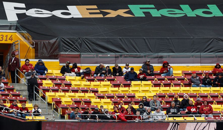 The announced paid attendance was 71,026, but empty seats filled the stands at FedEx Field to watch the Redskins beat the Cardinals on Sunday. (Associated Press)