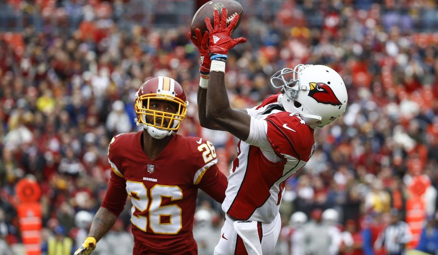 Arizona Cardinals wide receiver J.J. Nelson (14) pulls in a pass as Washington Redskins cornerback Bashaud Breeland (26) closes in during the first half of an NFL football game in Landover, Md., Sunday, Dec 17, 2017. (AP Photo/Patrick Semansky)