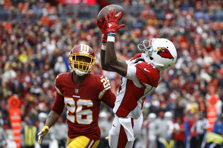 Arizona Cardinals wide receiver J.J. Nelson (14) pulls in a pass as Washington Redskins cornerback Bashaud Breeland (26) closes in during the first half of an NFL football game in Landover, Md., Sunday, Dec 17, 2017. (AP Photo/Patrick Semansky)