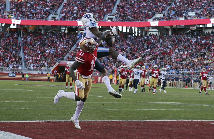 Tennessee Titans cornerback Adoree' Jackson, top, breaks up a pass in the end zone intended for San Francisco 49ers wide receiver Marquise Goodwin (11) during the second half of an NFL football game, Sunday, Dec. 17, 2017, in Santa Clara, Calif. (AP Photo/John Hefti)