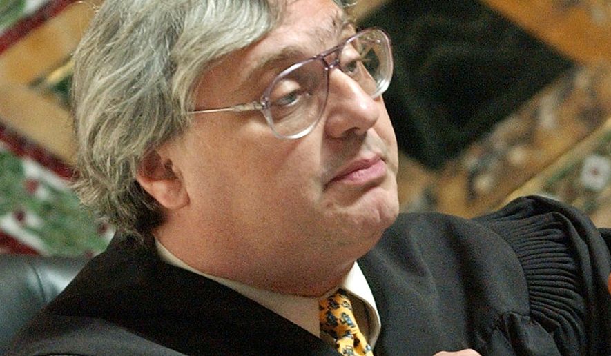 FILE - In this Sept. 22, 2003, file photo, Judge Alex Kozinski, of the 9th U.S. Circuit Court of Appeals, gestures in San Francisco. Krazinski announced his immediate retirement Monday, Dec. 18, 2017, days after women alleged he subjected them to inappropriate sexual conduct or comments. Kozinski said in a statement Monday that a battle over the accusations would not be good for the judiciary. (AP Photo/Paul Sakuma, Pool, File)