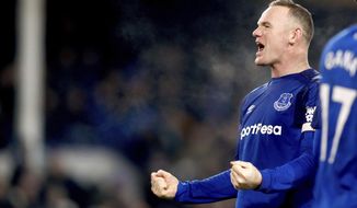 Everton&#39;s Wayne Rooney celebrates scoring his side&#39;s third goal of the game from the penalty spot during their English Premier League soccer match Everton versus Swansea City at Goodison Park, Liverpool, England, Monday, Dec. 18, 2017. (Martin Rickett/PA via AP)