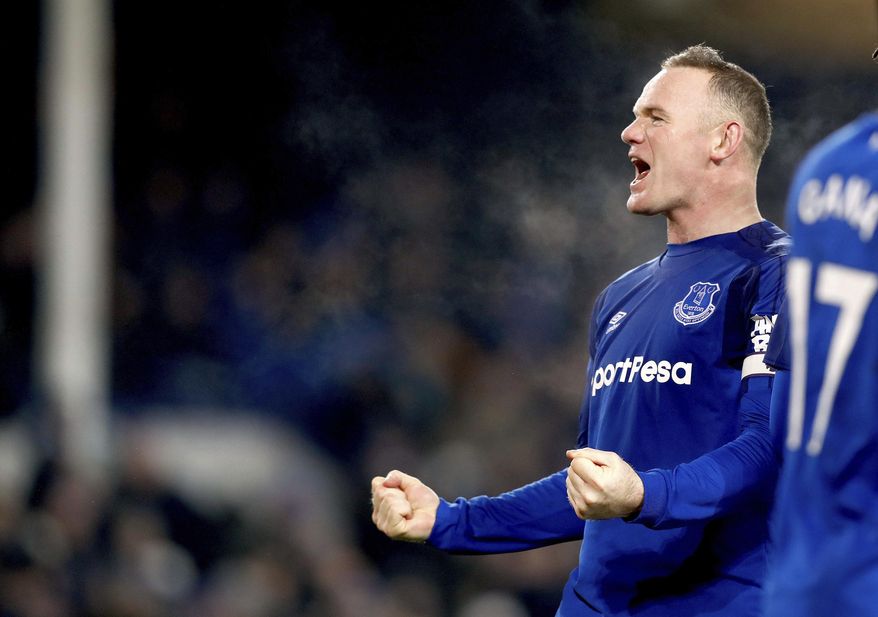 Everton&#39;s Wayne Rooney celebrates scoring his side&#39;s third goal of the game from the penalty spot during their English Premier League soccer match Everton versus Swansea City at Goodison Park, Liverpool, England, Monday, Dec. 18, 2017. (Martin Rickett/PA via AP)