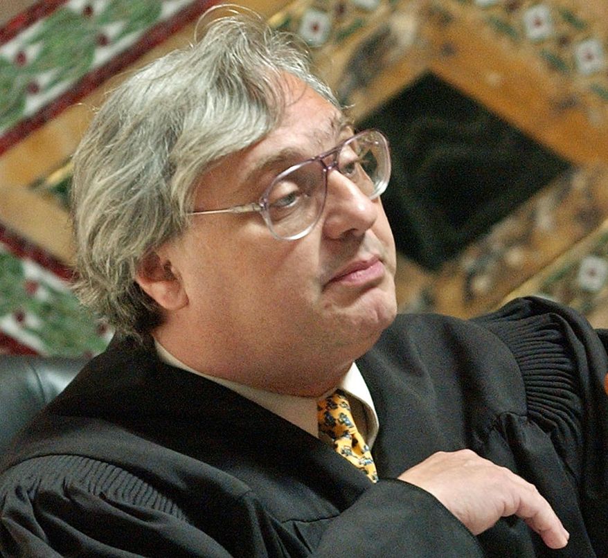 FILE - In this Sept. 22, 2003, file photo, Judge Alex Kozinski, of the 9th U.S. Circuit Court of Appeals, gestures in San Francisco. Krazinski announced his immediate retirement Monday, Dec. 18, 2017, days after women alleged he subjected them to inappropriate sexual conduct or comments. Kozinski said in a statement Monday that a battle over the accusations would not be good for the judiciary. (AP Photo/Paul Sakuma, Pool, File)