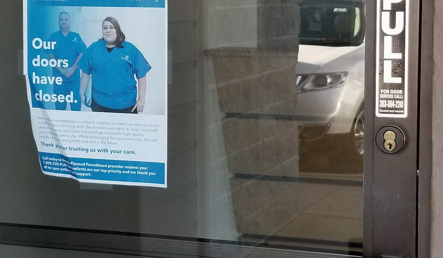 A sign taped to the window informs people of the closure of the Planned Parenthood clinic in Parker, Colorado. It was one of the 32 Planned Parenthood centers that shut down this year, according to a study. (Bradford Richardson/The Washington Times)