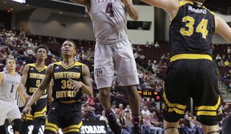 Texas A&amp;amp;M guard JJ Caldwell (4) puts up a shot between Northern Kentucky guard Lavone Holland II (30) and forward Drew McDonald (34) during the first half of an NCAA college basketball game Tuesday, Dec. 19, 2017, in College Station, Texas. (AP Photo/Michael Wyke)