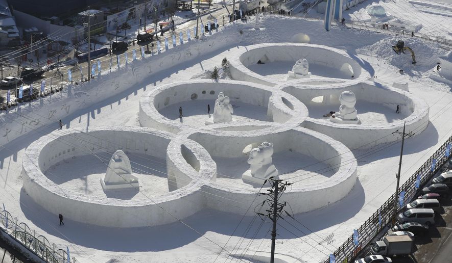 FILE - In this Feb. 2, 2017, file photo, visitors tour near the snow sculpture in the shape of the Olympic rings displaying at the Daegwanryung Snow festival in Pyeongchang, South Korea. South Korea&#x27;s Pyeongchang is the host city of the 2018 Olympic and Paralympic Winter Games which will start from February 2018. (AP Photo/Lee Jin-man, File)