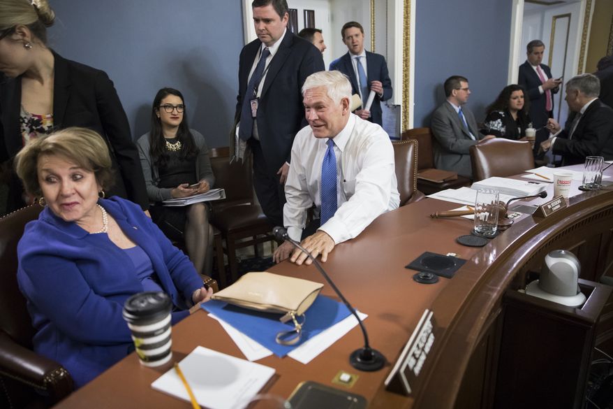 House Rules Committee Chairman Pete Sessions, R-Texas, center, with Rep. Louise Slaughter, D-N.Y., the ranking member, left, meet early Wednesday, Dec. 20, 2017, to approve some procedural corrections in the final version of the Republican tax bill, on Capitol Hill, in Washington. (AP Photo/J. Scott Applewhite)