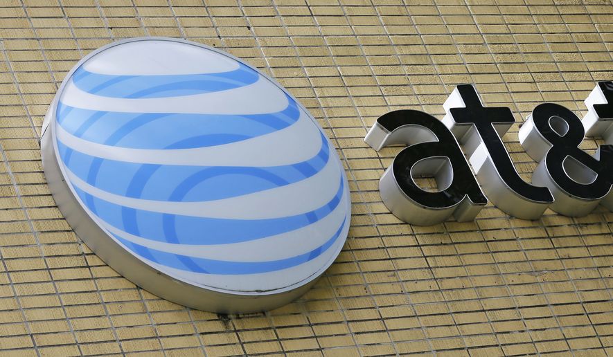 This Thursday, Oct. 12, 2017, file photo shows an AT&amp;T sign at a store in Miami. On Dec. 20, 2017, the company announced it was giving employees a $1,000 bonus in celebration of congressional passage of federal tax reform. (AP Photo/Alan Diaz, File) **FILE**