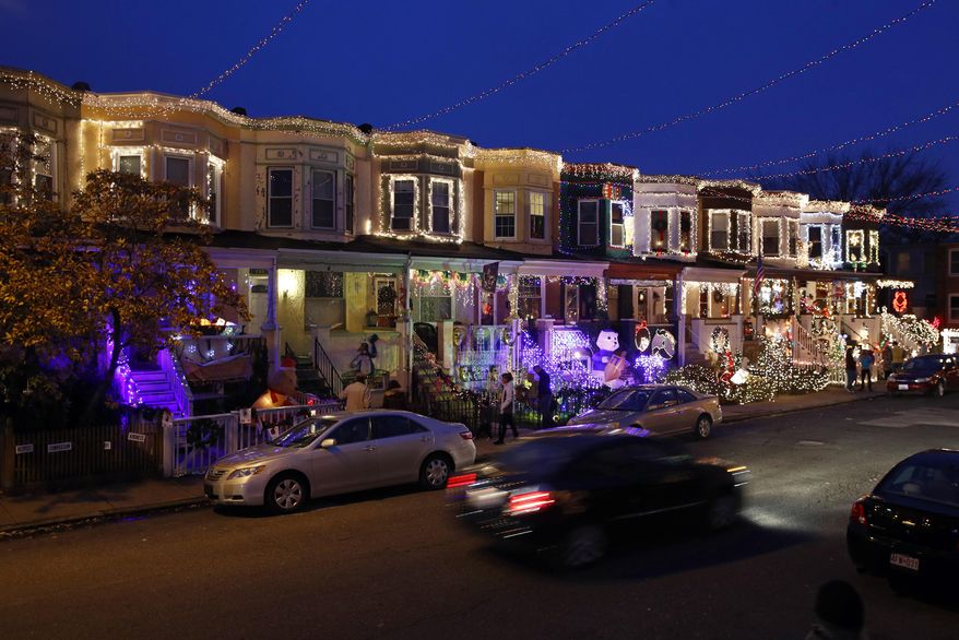 In this Dec. 6, 2017, file photo, row houses in the Hampden neighborhood of Baltimore show off Christmas decorations. Known as "The Miracle on 34th Street," the dramatically over-the-top decor along the block is perhaps Baltimore's most beloved seasonal institution, attracting thousands of gawkers each December. (AP Photo/Patrick Semansky) ** FILE **