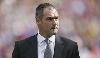 FILE - A Saturday, Aug. 26, 2017 file photo of Swansea City&#39;s manager Paul Clement as he looks at the stands before the English Premier League soccer match between Crystal Palace and Swansea City at Selhurst Park in London. Swansea fired Paul Clement Wednesday, Dec. 20, 2017, just before the manager completed a year in charge of the Premier League club. (AP Photo/Tim Ireland, File)