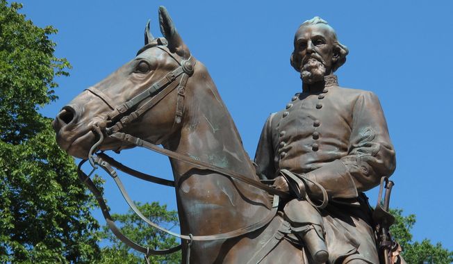 File- In this Aug. 18, 2017, photo, a statue of Confederate Gen. Nathan Bedford Forrest sits in a park in Memphis, Tenn. A city council in Tennessee has voted to sell two city parks where two Confederate statues are located and crews have begun work to remove one of them. The Commercial Appeal reports Memphis Mayor Jim Strickland said in a tweet Wednesday, Dec. 20, 2017, that the parks were sold and that work underway there complies with state law. The city council unanimously approved the sale Wednesday to a private entity.  (AP Photo/Adrian Sainz, File)