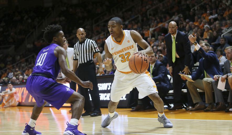 Tennessee guard Chris Darrington (32) is defended by Furman guard Alex Hunter (10) in the first half of an NCAA college basketball game Wednesday, Dec. 20, 2017, in Knoxville, Tenn. (AP Photo/Crystal LoGiudice)
