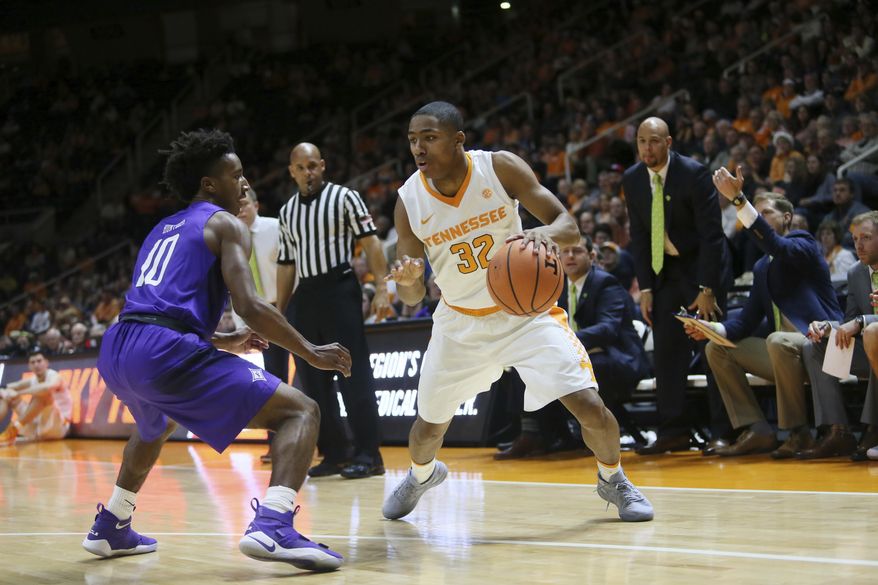 Tennessee guard Chris Darrington (32) is defended by Furman guard Alex Hunter (10) in the first half of an NCAA college basketball game Wednesday, Dec. 20, 2017, in Knoxville, Tenn. (AP Photo/Crystal LoGiudice)