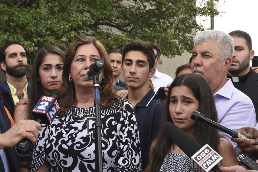 FILE - In this June 16, 2017 file photo, Lindsey Hamama, 11, right, cries as her mother Nahrain speaks to the crowd in Detroit, about her father Usama "Sam" Hamama, who was detained during Immigration and Customs Enforcement raids of primarily Chaldean immigrants, in which 114 Iraqi nationals in Metro Detroit were detained and are facing deportation. A federal judge in Detroit is mulling whether to release her father, Hamama, who was apprehended by immigration officials as part of a roundup in June, and hundreds of others whose deportations to Iraq were suspended but remain in custody. U.S. District Judge Mark Goldsmith, who will hear arguments on Wednesday, Dec. 20, 2017, blocked the deportation of 1,400 people in July to allow time to challenge their removal in immigration court. (Tanya Moutzalias/The Ann Arbor News-MLive.com Detroit via AP)