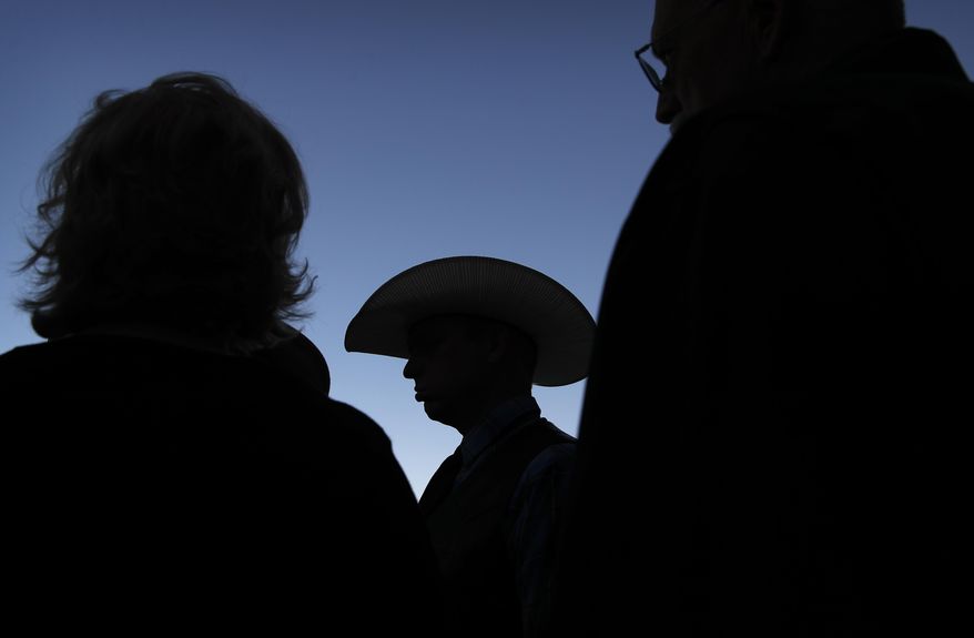 Ryan Bundy, center, stands outside of a federal courthouse Wednesday, Dec. 20, 2017, in Las Vegas. Chief U.S. District Judge Gloria Navarro declared a mistrial Wednesday in the case against Cliven Bundy, his sons Ryan and Ammon Bundy and self-styled Montana militia leader Ryan Payne. (AP Photo/John Locher)