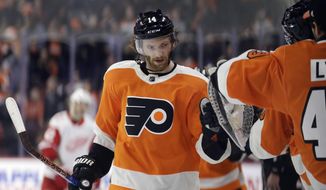 Philadelphia Flyers&#39; Sean Couturier celebrates with his teammates after scoring during the third period of an NHL hockey game against the Detroit Red Wings, Wednesday, Dec. 20, 2017, in Philadelphia. Philadelphia won 4-3. (AP Photo/Matt Slocum)
