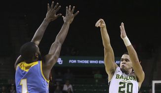 Baylor guard Manu Lecomte (20) shoots a 3-pointer over Southern University guard LaQuentin Collins during the first half of an NCAA college basketball game, Wednesday, Dec. 20, 2017, in Waco, Texas. (AP Photo/Jerry Larson)