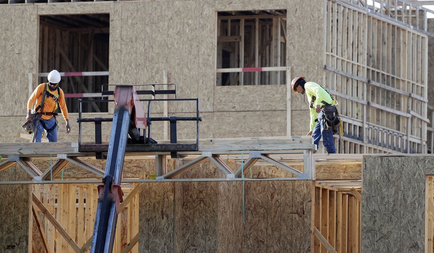 In this July 12, 2017, photo, construction workers build a residential complex in Nashville, Tenn. The U.S. economy grew at a 3.2 percent annual rate from July through September, slightly slower than previously estimated but still enough to give the country the best back-to-back quarterly growth rates in three years. (AP Photo/Mark Humphrey)