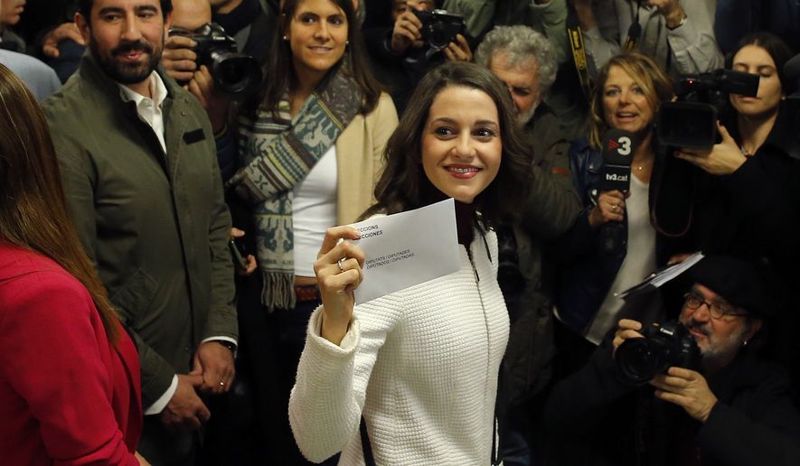 Ciutadans (Citizens) party leader Ines Arrimadas displays her ballot envelope before voting for the Catalan regional election in Barcelona, Spain, on Thursday, Dec. 21, 2017. Catalans are choosing new political leaders in a highly contested election called by central authorities to quell a separatist bid in Spain's northeastern region. (AP Photo/Manu Fernandez)