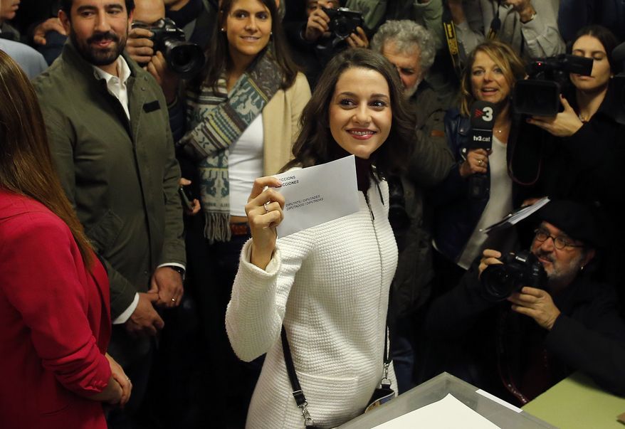 Ciutadans (Citizens) party leader Ines Arrimadas displays her ballot envelope before voting for the Catalan regional election in Barcelona, Spain, on Thursday, Dec. 21, 2017. Catalans are choosing new political leaders in a highly contested election called by central authorities to quell a separatist bid in Spain's northeastern region. (AP Photo/Manu Fernandez)