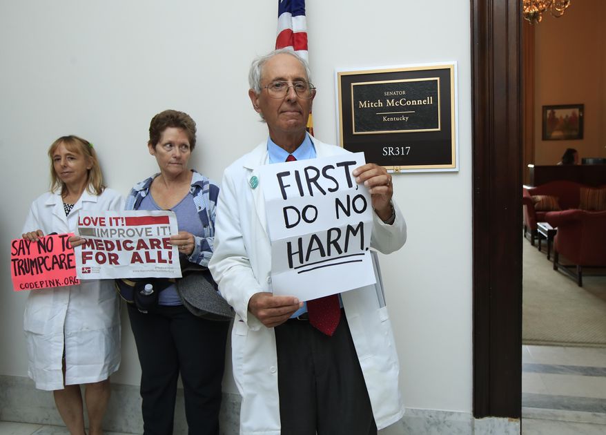 In this July 17, 2017 photo, retired family physician Jay Brock of Fredericksburg, Va., joins other protesters against the Republican health care bill outside the office of Senate Majority Leader Mitch McConnell of Ky., on Capitol Hill in Washington. A year after a big change in leadership, a survey by The Associated Press-NORC Center for Public Affairs Research finds that 48 percent named health care as a top problem for the country. (AP Photo/Manuel Balce Ceneta)
