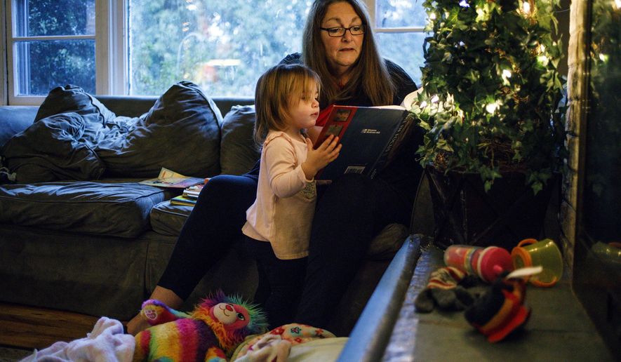 In this Nov. 30, 2017 photo, Carter Gens engages her grandmother Joanne Clough in one of her favorite activities - reading at their home in Camp Hill, Pa. Clough, 60, is raising her granddaughter Carter since Carter's mother died of a fentanyl overdose last year. Clough's daughter Emily Roznowski, the mother of Carter, died on Dec. 3, 2016. (Dan Gleiter | dgleiter /PennLive.com via AP)