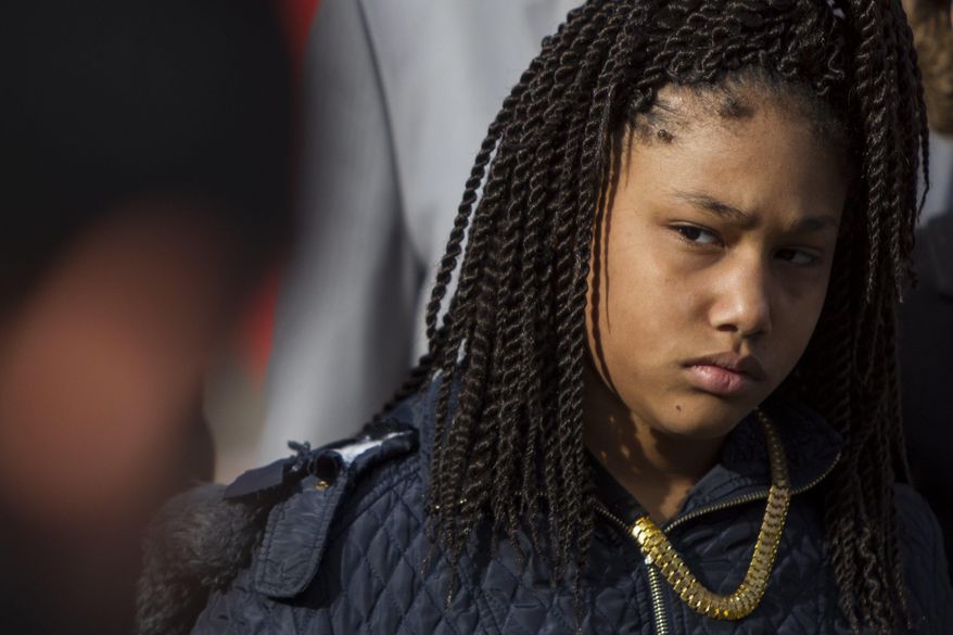 Honestie Hodges, 11, listens during a Greater Grand Rapids NAACP press conference at Calder Plaza in downtown Grand Rapids, Mich., on Tuesday, Dec. 19, 2017. The local NAACP says Grand Rapids police used excessive force in the controversial handcuffing of Honestie at gunpoint while searching for a stabbing suspect on Dec. 6. (Cory Morse /The Grand Rapids Press via AP)
