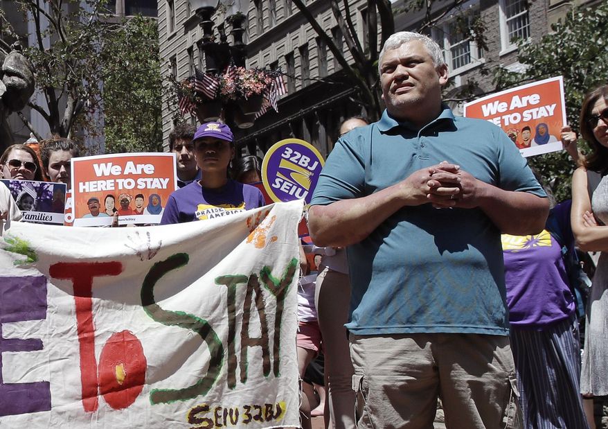 File- In this July 6, 2017 file photo, MIT janitor Francisco Rodriguez listens to speakers during a "Here to Stay" rally at the Irish Famine Memorial in Boston. Rodriguez, who was facing deportation to El Salvador, has been released from a Boston jail. Francisco Rodriguez-Guardado was released by U.S. Immigration and Customs Enforcement on Thursday. Dec. 21, 2017, after being held since July at the Suffolk County House of Corrections. His lawyers say his removal proceedings have been stayed pending their request to reopen his asylum case. Rodriguez-Guardado's mother says the family is "overjoyed." (AP Photo/Charles Krupa)