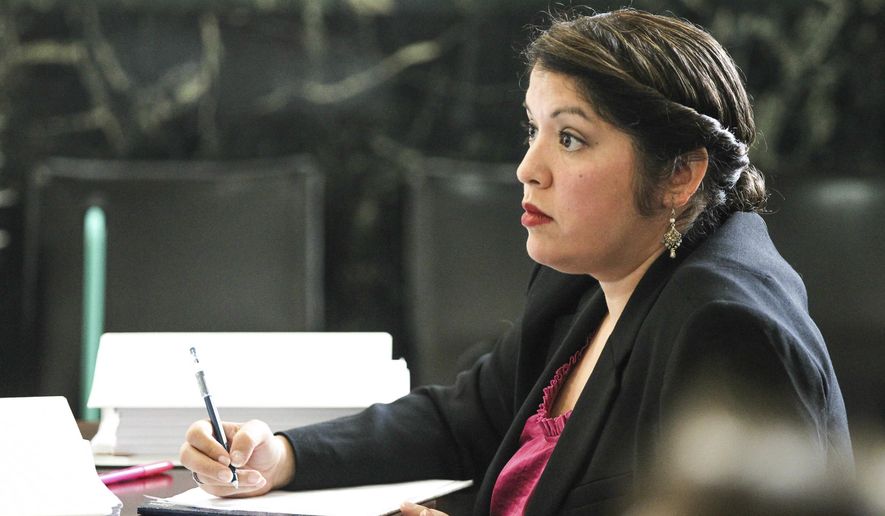 FILE- In this Aug. 8, 2017, file photo, Monika Burgett listens to opening statements during her trial in Cincinnati. Burgett, who prosecutors say falsely claimed her young son had terminal cancer, pretended to be a doctor and fraudulently raised funds for him has been sentenced to probation. The Cincinnati Enquirer reports a Hamilton County judge told Burgett that she needs “significant help” before sentencing her Wednesday, Dec. 20, to five years of probation. (Phil Didion/The Cincinnati Enquirer via AP, File)