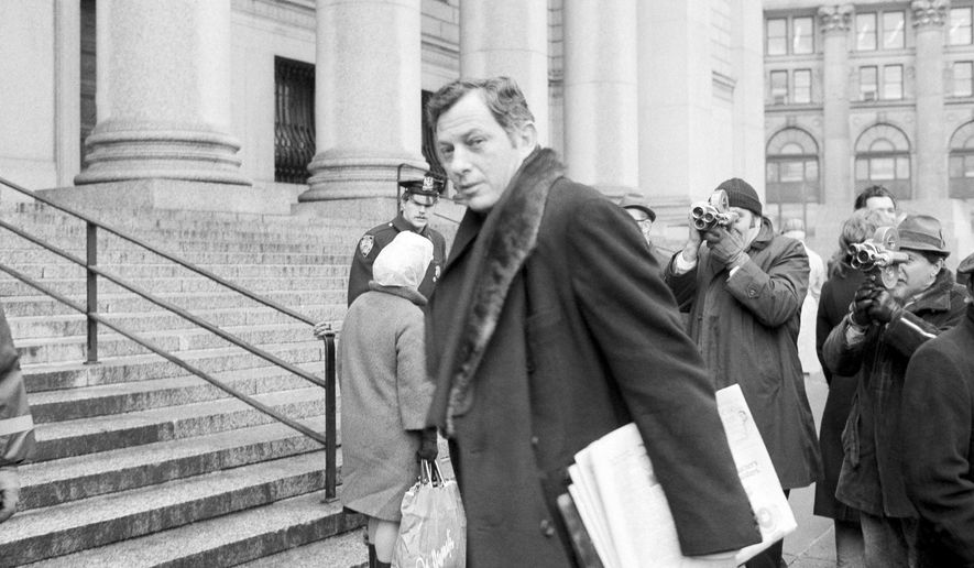 File - In this March 13, 1972 file photo, author Clifford Irving is seen as he enters federal court in New York. Irving, the prankster who wrote a phony autobiography of billionaire Howard Hughes and fooled a major publisher in 1971 has died at 87. The New York Times reports Irving's wife, Julie Irving, confirmed that he died Tuesday, Dec, 19, 2017, at a hospice near his Sarasota home. (AP Photo/Jim Wells, File)