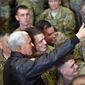 U.S. Vice President Mike Pence poses for photos with troops at Bagram Air Base in Afghanistan on Thursday, Dec. 21, 2017. (Mandel Ngan/Pool via AP)