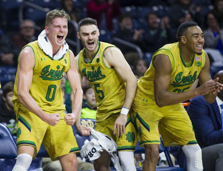 Notre Dame's Rex Pflueger (0) Matt Farrell (5) Bonzie Colson (35) celebrate as a teammate scores during an NCAA college basketball game against Southeastern Louisiana in South Bend, Ind., Thursday, Dec. 21, 2017. (Michael Caterina/South Bend Tribune via AP)
