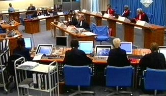FILE - In this Tuesday Sept. 7, 2004 file image made from TV, Slobodan Milosevic, second from top left, appears before the International Criminal Tribunal for the former Yugoslavia (ICTY) in The Hague, The Netherlands. After nearly a quarter century of prosecuting Balkan wars atrocities, the United Nations’ Yugoslav war crimes tribunal is closing down with no fugitives left on the run, many major suspects convicted but denial of crimes and glorification of war criminals still rife in the region. (ICTY, File via AP)
