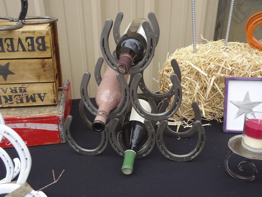 This Dec. 7, 2017 photo shows a wine rack made of horseshoes by welder and metal fabricator Jerry "J.J." Ring in Thomasville, N.C. (Jimmy Tomlin/The High Point Enterprise via AP)
