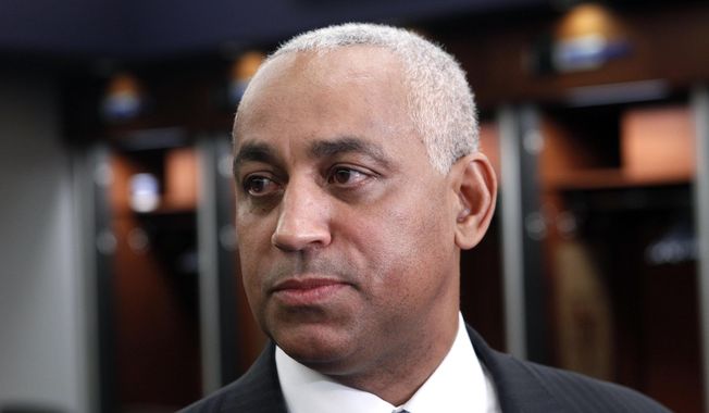 FILE - In this Oct. 4, 2010, file photo, Omar Minaya speaks to the media in the New York Mets clubhouse at Citi Field in New York. Minaya is returning to the Mets as a special assistant to Sandy Alderson, who replaced him as general manager after the 2010 season. (AP Photo/Seth Wenig, File)