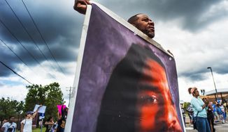In this June 18, 2017 file photo, John Thompson, who said he was a close friend of Philando Castile, protests during a demonstration in St. Anthony, Minn. The protesters marched against the acquittal of Police Officer Jeronimo Yanez, who was found not guilty of manslaughter for shooting Castile during a traffic stop.  (Richard Tsong-Taatarii /Star Tribune via AP, File)  **FILE**