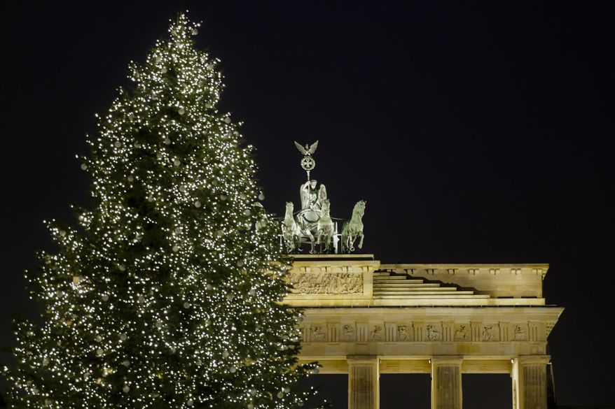 A Christmas tree is illuminated in front of Germany&#39;s landmark Brandenburg Gate a day before Christmas Eve in Berlin, Saturday, Dec. 23, 2017. (AP Photo/Markus Schreiber) **FILE**