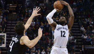 Memphis Grizzlies guard Tyreke Evans (12) attempts a three point shot against Los Angeles Clippers guard Milos Teodosic (4) in the second half of an NBA basketball game Saturday, Dec. 23, 2017, in Memphis, Tenn. The Grizzlies won 115-112. (AP Photo/Brandon Dill)